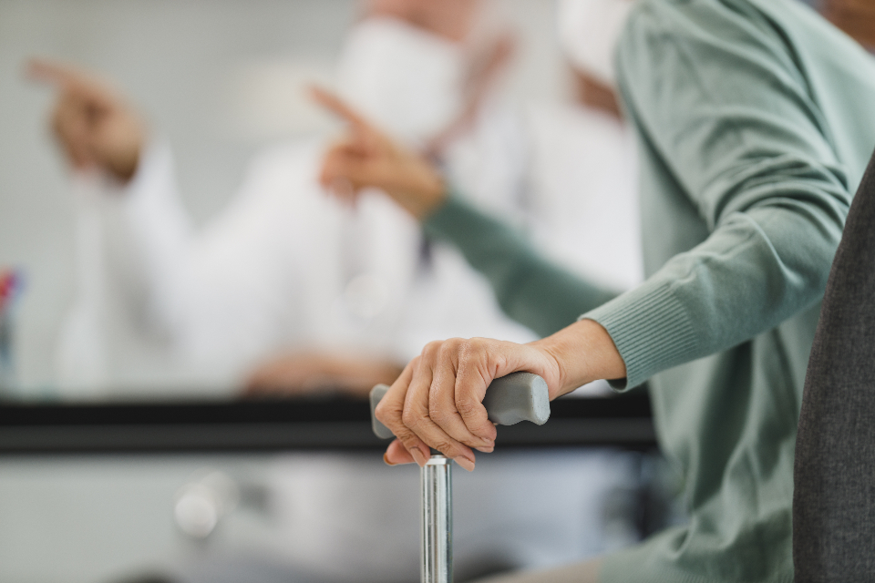 A clinician steadying a patient's hand